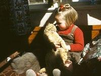 Young Robyn with cats